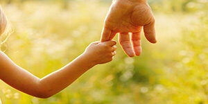 Child is holding parent's hand